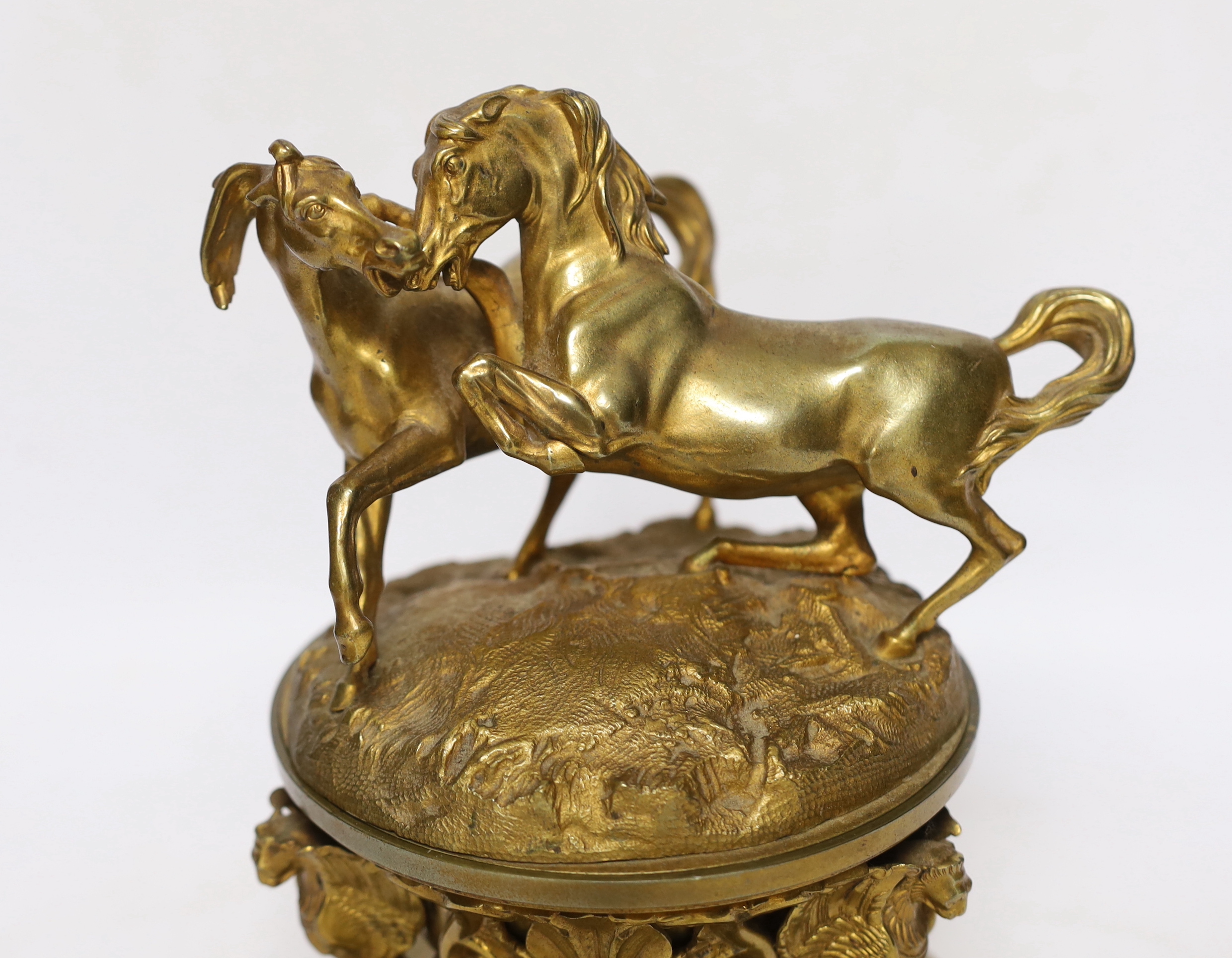 A late 19th century French ormolu dish and cover, surmounted by fighting stallions, 24cm high